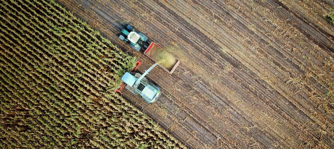 Aerial photo of agricultural machinery harvesting crops